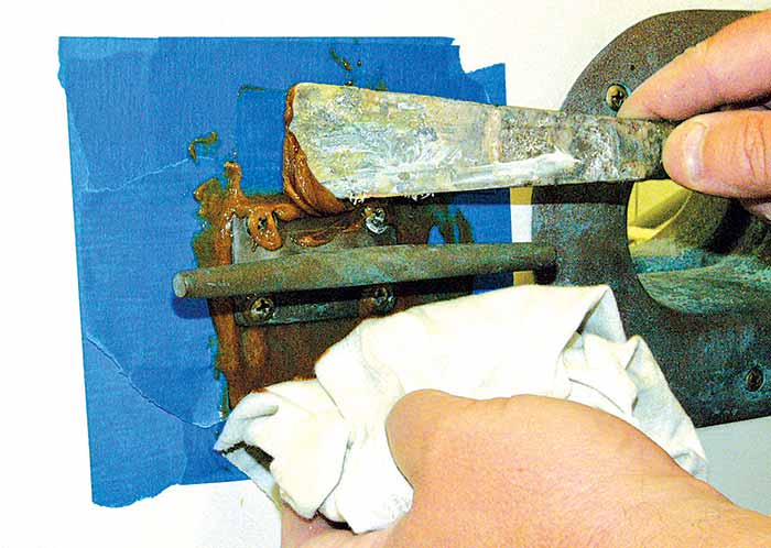 Scrape excess compound off